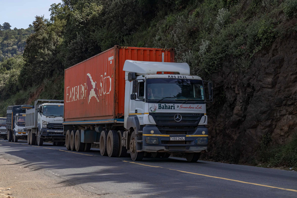 Truck carrying a shipping container on a mountain road