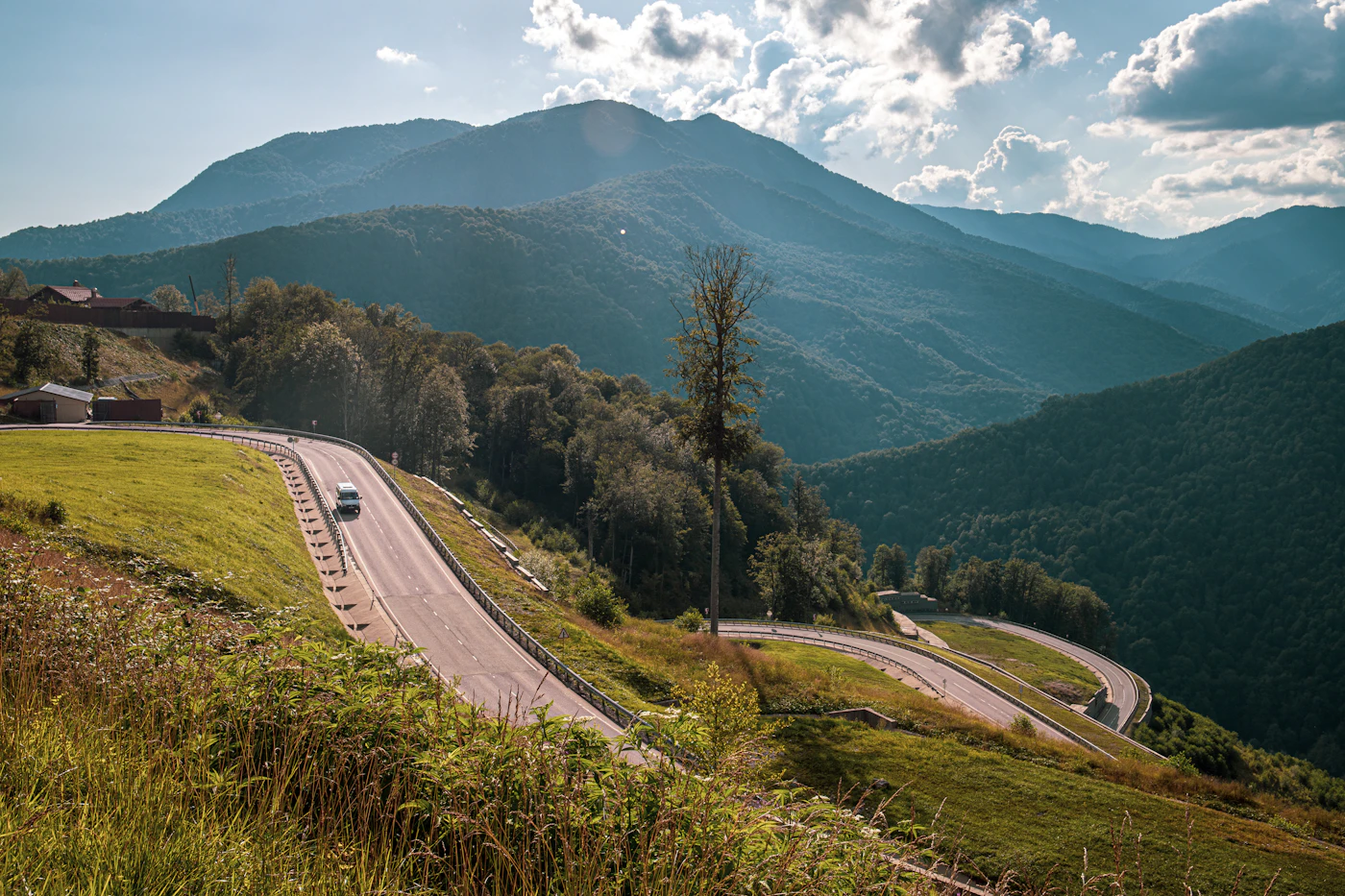 Mountain road winding through green hills